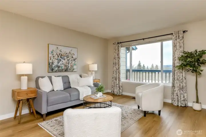 Living room on upper floor. The condo has new flooring and there is a wonderful territorial view form the deck