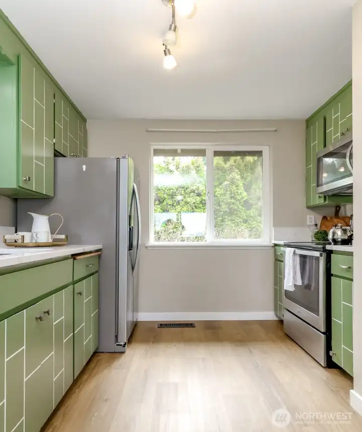 Window looks out to the front of the condo and stairs leading to the parking lot, designated carport and storage shed.