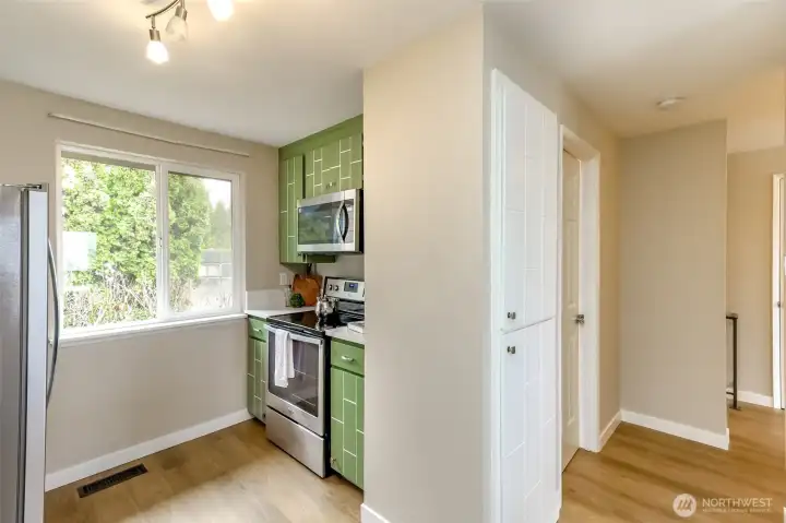 The stacked built in cabinets are kitchen pantry storage. Hall leads to half bathroom to the left.