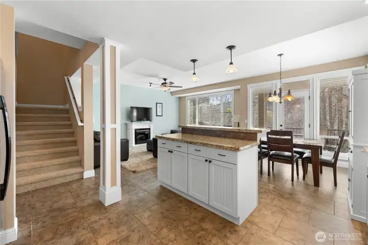 Main Floor Kitchen island - stairs up to 2 suites