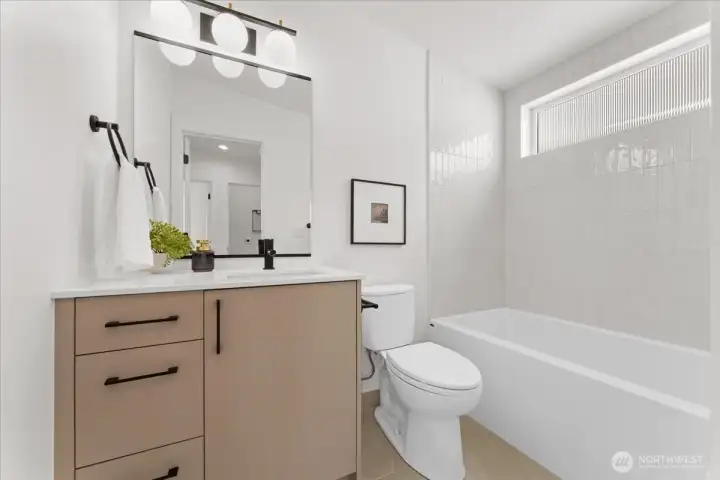 Shared full bathroom upstairs. Photo of model unit, 4118. Finishes may vary, buyer to verify.