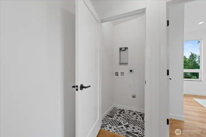 Upstairs laundry room. Photo of model unit, 4118. Finishes may vary, buyer to verify.