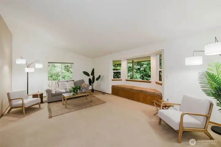 Large living room with vaulted ceils plus a window seat with extra storage under the cusions