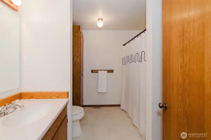 Full Bathroom with laundry chute in linen closet