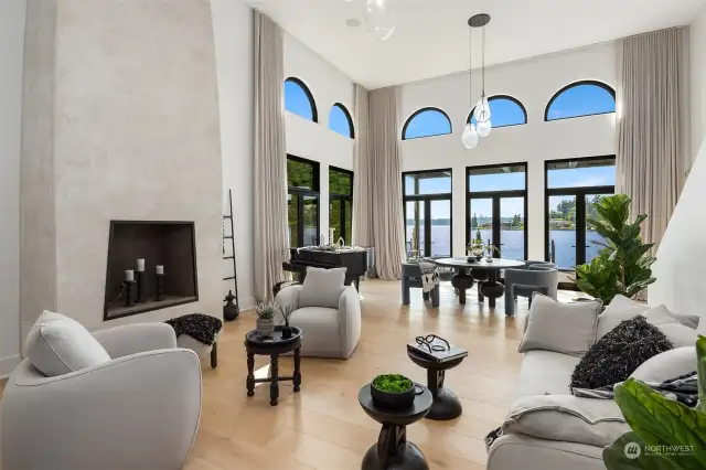 The main level features cathedral ceilings, a two-story plaster fireplace, automated blinds throughout, and a spacious terrace to soak in the captivating views.