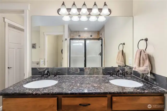 Granite counters with double sinks and separate commode room