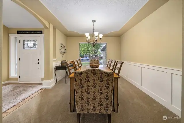 Formal dining room with all those craftsman touches to include rounded doorways, decorative batten and board trim and tray ceiling