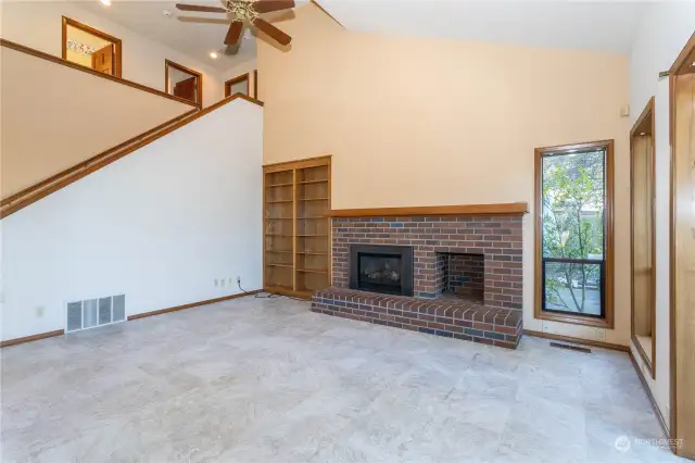 Family room with view of fireplace & staircase two 2nd floor