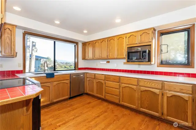 Window at kitchen sink has view of mountains