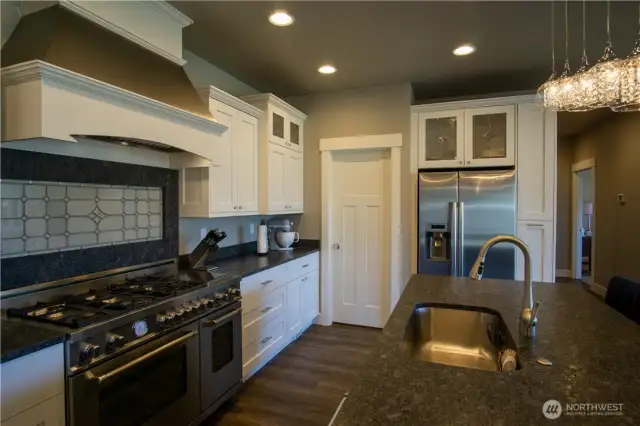 Custom backsplash and granite leatherd finish countertops.