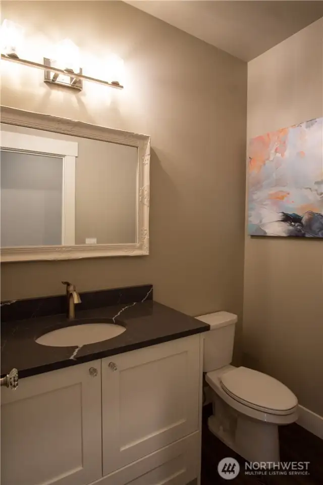 Powder room off of the kitchen and formal dining area.