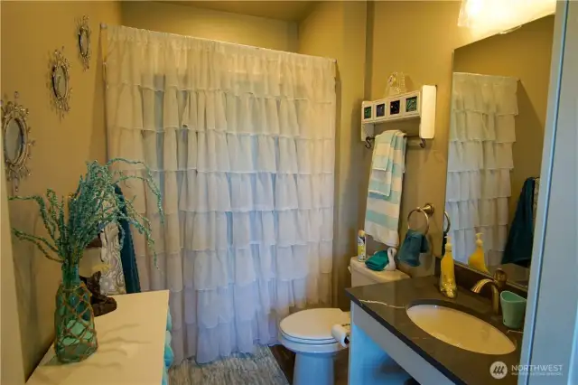 ADU bathroom with walk-in shower and built in seating inside.