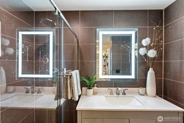 Floor to ceiling tiles make a dramatic statement in the primary bedroom's en-suite bath.
