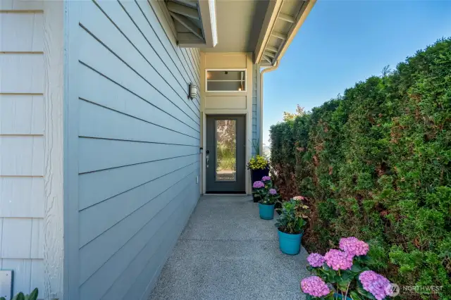 Manicured landscaping and charming walkway to your front door.