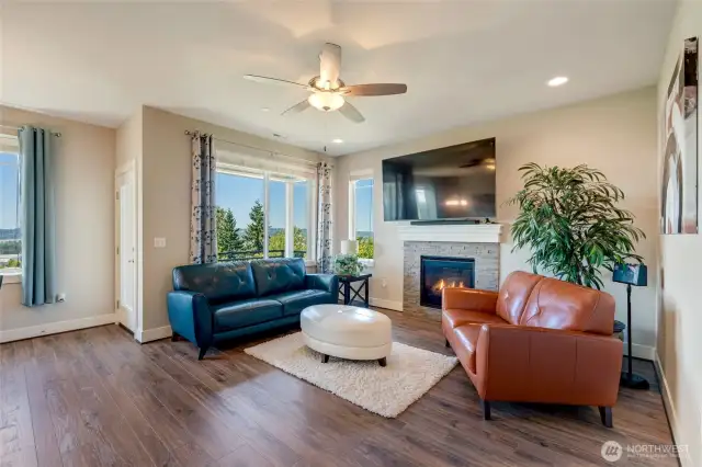 Cozy gas fireplace anchors the living room.