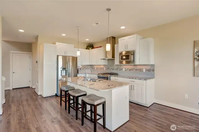 Sleek stainless steel appliances and center island.