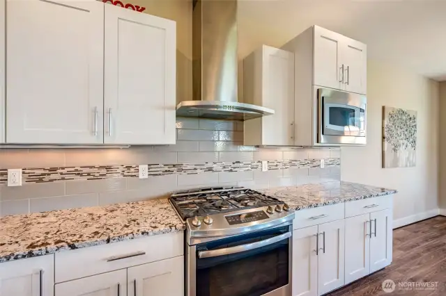 Gourmet kitchen with granite counters and full backsplash.