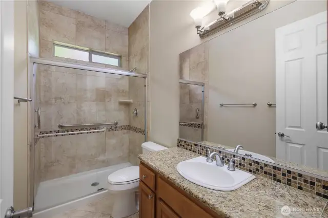 2nd Primary Bathroom with granite countertops and full tile shower.