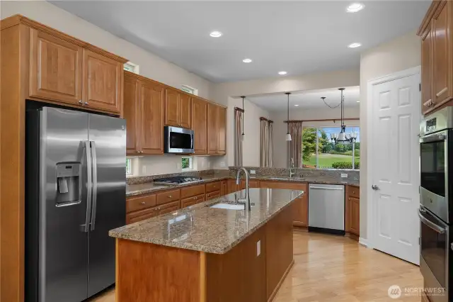 Stunning Kitchen with Granite Countertops, pullout shelves, Double oven, and stainless steel appliances.
