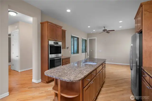 Stunning Kitchen with Granite Countertops, pullout shelves, Double oven, and stainless steel appliances.