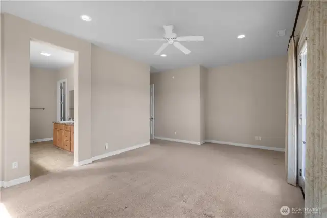 Primary bedroom featuring French doors to covered porch and blackout blinds for comfort.