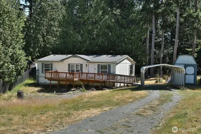 Set back from the road and close to the adjacent forest, you will love the privacy of this lot. There is a sweet garden shed/workshop space, too!