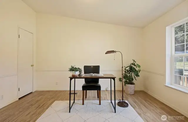This room is staged as an office, however, could easily be a bedroom or guest space. The door on the left edge of this photo is a closet.