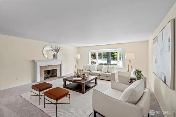 The living room is filled with natural light from the bay window