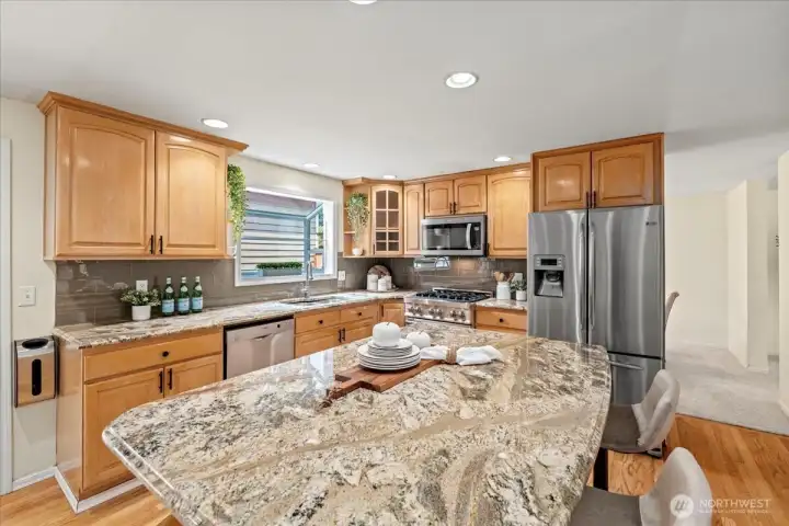 The beautiful kitchen features granite counters and an expansive island