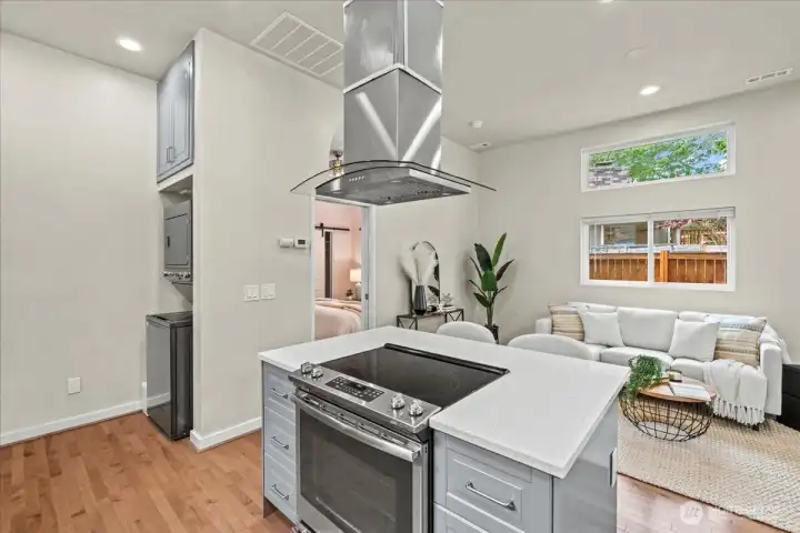 Stackable washer and dryer are conveniently located next to the kitchen.