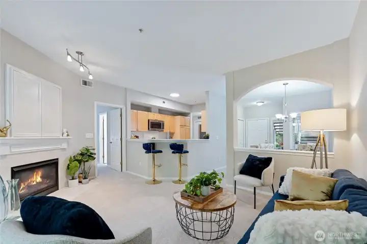 View looking toward the kitchen gives a great perspective of the open concept. This room is open, yet warm and inviting. *Room features new carpet, fresh paint, gas fireplace & entertainment nook.