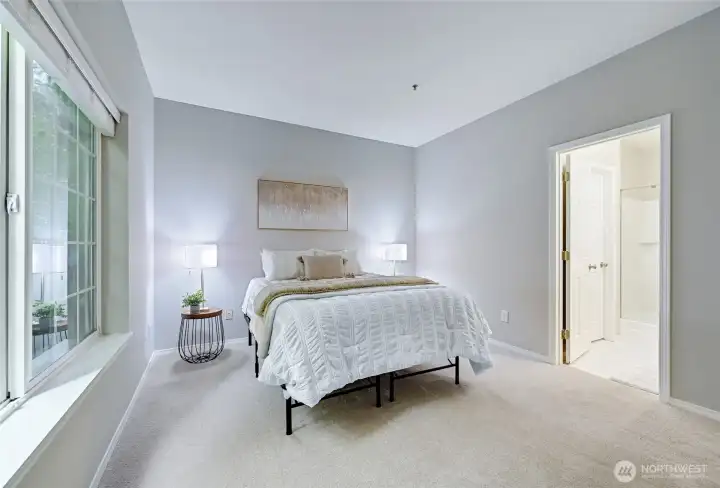 Enter the primary bedroom to explore how generously sized it is. Queen sized bed now, but a King would fit just fine. Lots of space for additional furnishings as well. Door to the right will lead us to the primary bathroom.