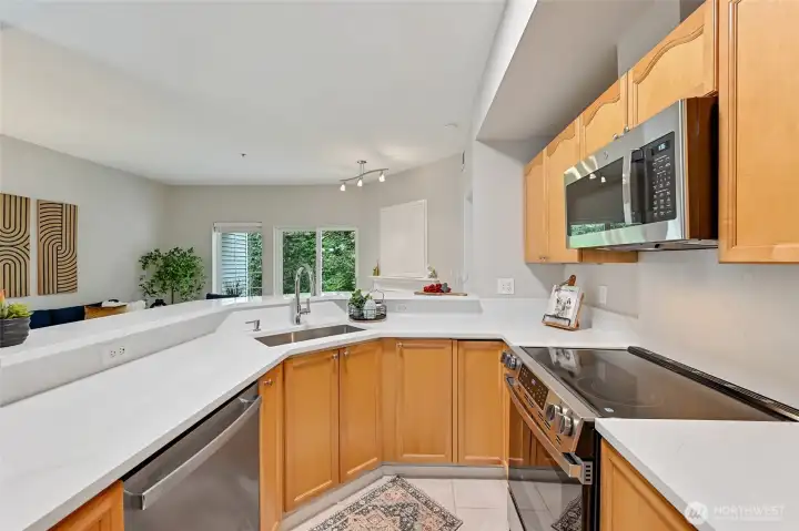 Your beautiful kitchen has a double level set-up that is extra wonderful when entertaining. It keeps the dirty dishes out of sight! The countertop has a nice bar overhang with seating for at least two. Notice all the outlets?      If you're a baker those outlets come in very handy.