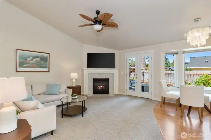 The soaring ceilings keep the room feeling casual and comfortable. (The lighting fixture over the breakfast table does not convey)