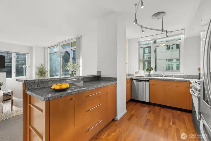 Kitchen – Features a custom-built island for casual dining, added prep space, and e
