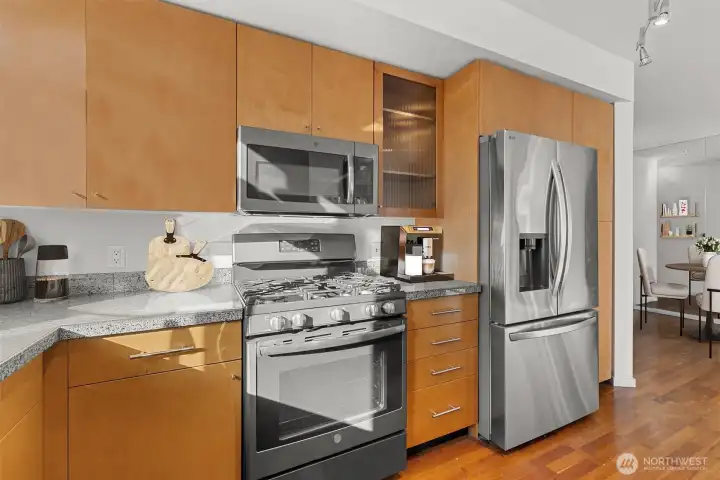 Kitchen – Features a custom-built island for casual dining, added prep space, and e