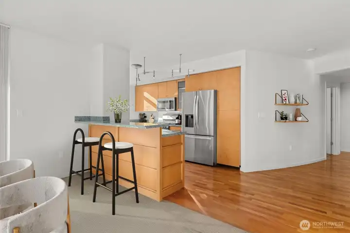 Kitchen – Features a custom-built island for casual dining, added prep space, and e