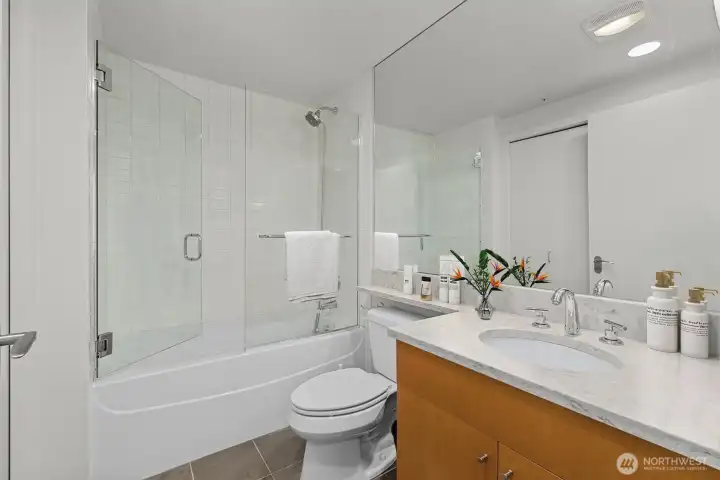 Guest bathroom – Includes a large soaking tub and custom glass doors for a refined touch
