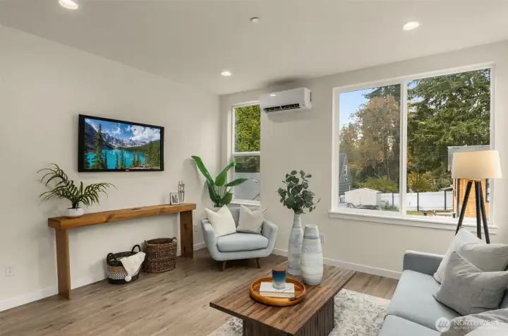 Expansive windows frame leafy neighborhood views, filling the space with golden light and highlighting the home’s timeless design.
