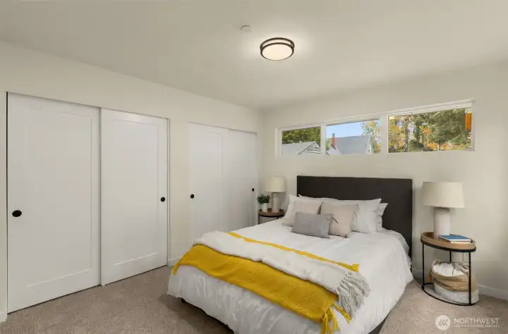 Crisp lines, warm hues, and generous closet space make this bedroom a stylish and serene retreat designed for true rest.