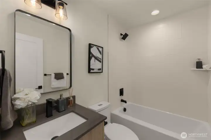 Polished mirrors, refined hardware, and rich cabinetry come together in this beautifully composed bathroom.