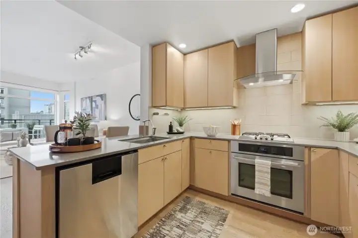 Here's a closer look at the custom kitchen including a gas cooktop, Jenn-Air refrigerator and oven, Zephr oven vent hood, slab granite countertops and Canyon Creek Cabinets.