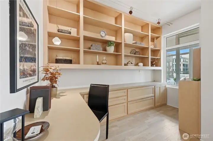 Check out this incredible den/home office with shelving, storage cabinets and plenty of desk and countertop space for maximum organization and efficiency.