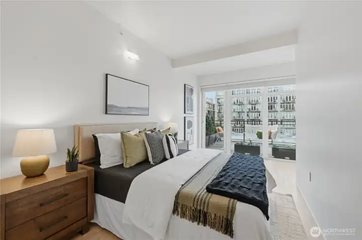 King size primary suite with access to the expansive outdoor deck, custom black out blinds and roller shades.