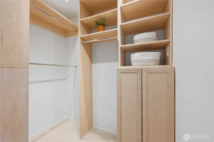 Lovely walk-in closet with custom organizers maximizing space.