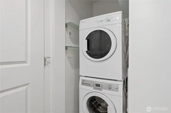 Stack laundry in the bathroom tucked neatly behind the door.