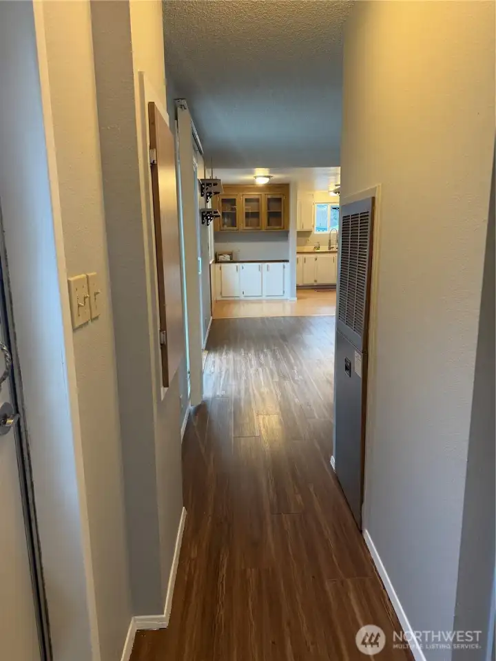 Stepping out of the bedroom looking down the hall back to the living area