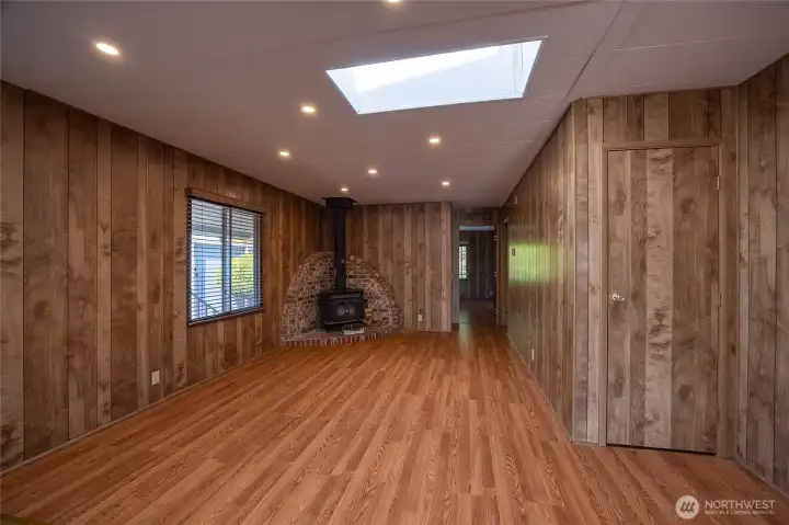 Dining room and Family Room with Wood Burning Stove and Skylight.