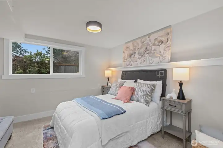 Main-level fourth bedroom offering flexibility for guests, home office, or multi-generational living.