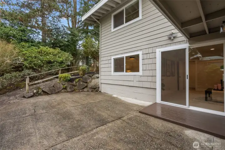 Sliding door opens to a private side patio—an extension of the main-level family room for seamless indoor-outdoor living.
